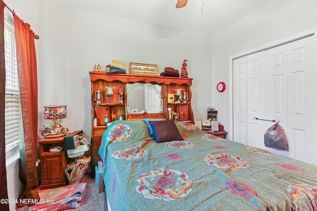 carpeted bedroom with a closet, multiple windows, and ceiling fan