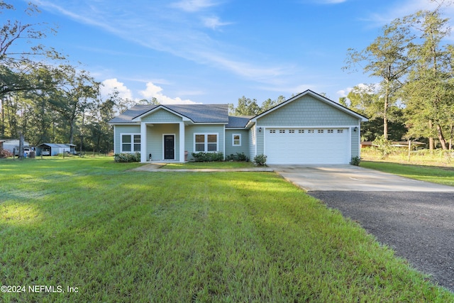 view of front of home featuring a front lawn and a garage