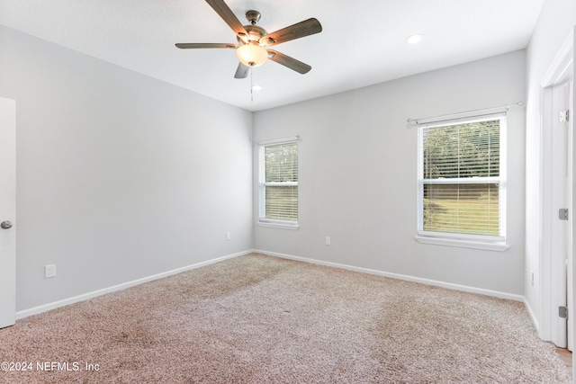 empty room featuring light carpet and ceiling fan