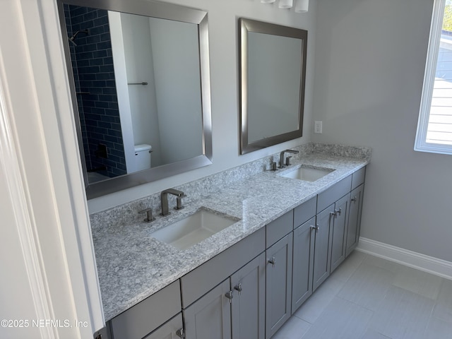 bathroom with vanity, tile patterned floors, and toilet