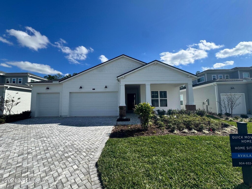 view of front of home featuring a garage and a front lawn