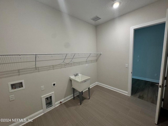 washroom featuring gas dryer hookup, wood-type flooring, hookup for an electric dryer, and hookup for a washing machine