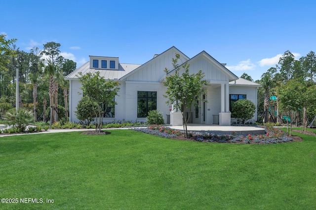 modern farmhouse style home featuring a playground and a front yard