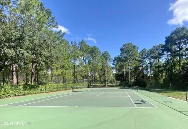 view of tennis court with basketball hoop