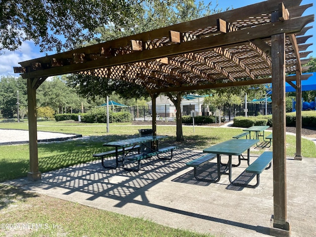 view of community with a yard and a pergola