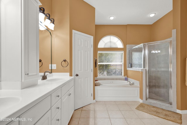 bathroom featuring plus walk in shower, tile patterned flooring, and vanity