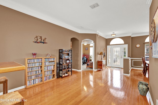 foyer featuring crown molding and wood-type flooring