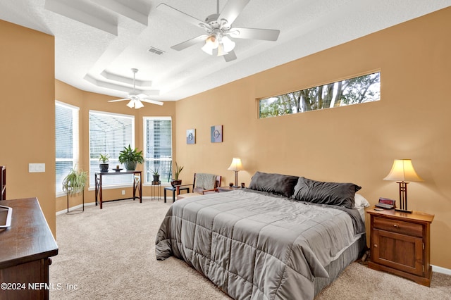 carpeted bedroom with a textured ceiling and ceiling fan