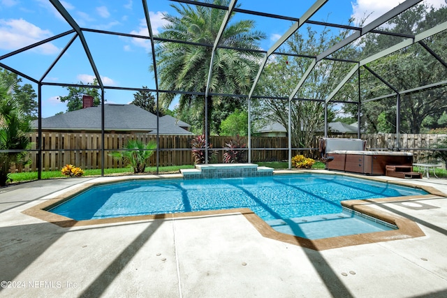 view of swimming pool with glass enclosure and a patio