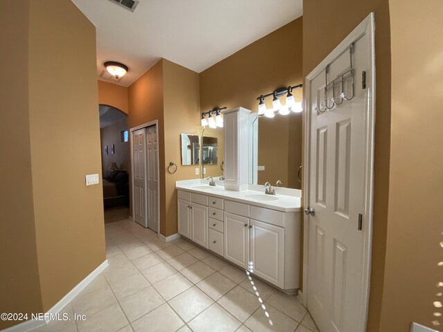 bathroom with tile patterned flooring and vanity