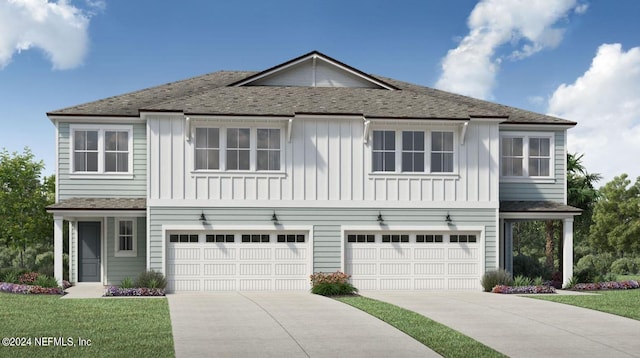 front of property with a front yard and a garage