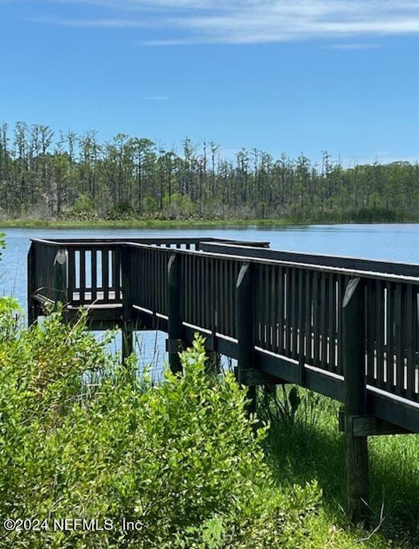 view of dock with a deck with water view