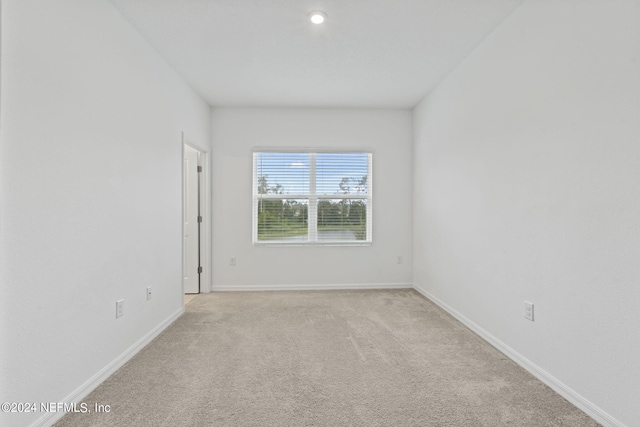 unfurnished room with light carpet