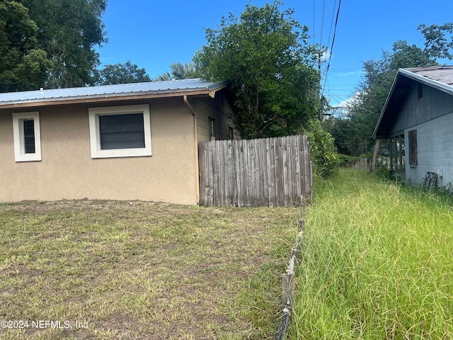 view of property exterior with a yard