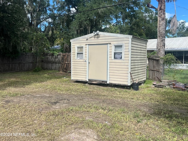 view of outbuilding with a lawn