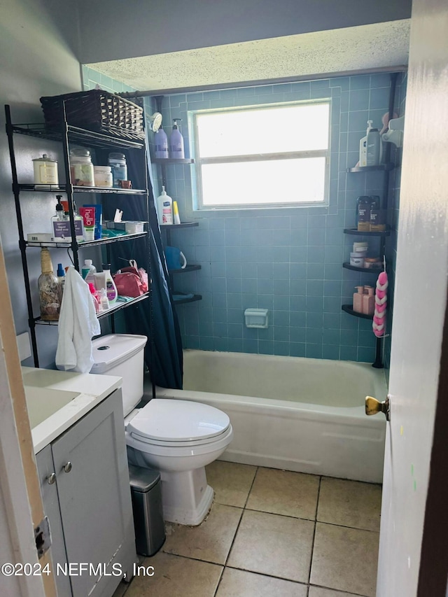 full bathroom featuring shower / bath combination with curtain, vanity, toilet, and tile patterned floors