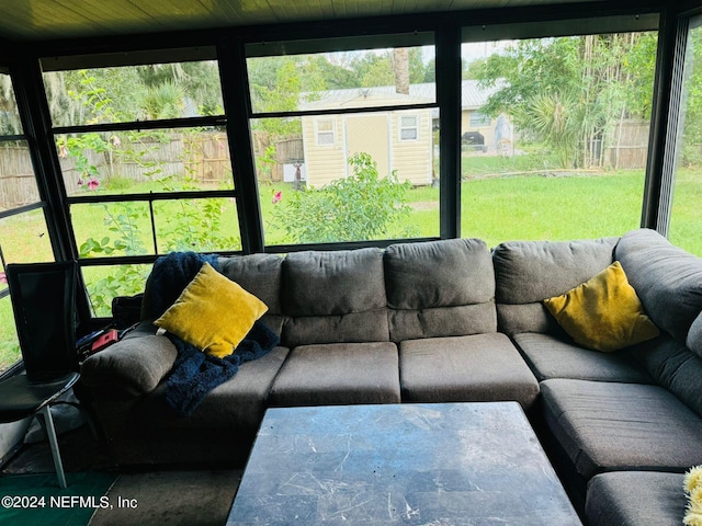 living room featuring wood ceiling and expansive windows