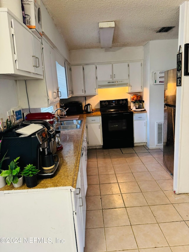 kitchen featuring white cabinets, light tile patterned flooring, sink, a textured ceiling, and black / electric stove