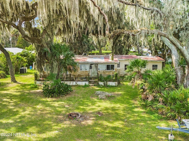 view of yard featuring a deck and central air condition unit