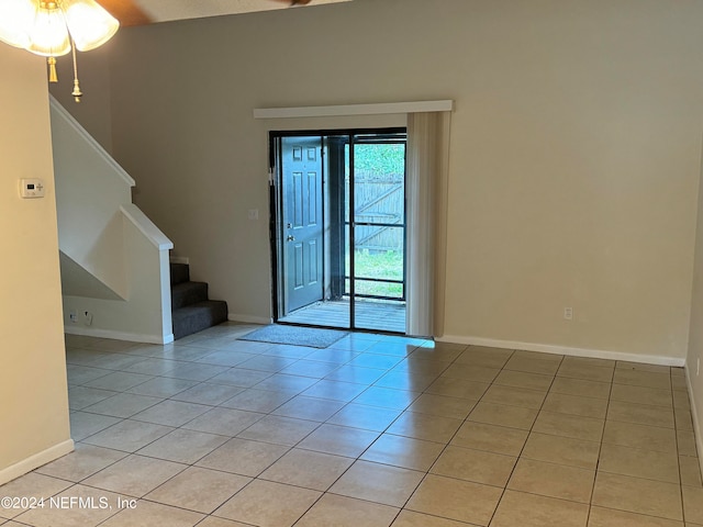 unfurnished room with ceiling fan and light tile patterned flooring