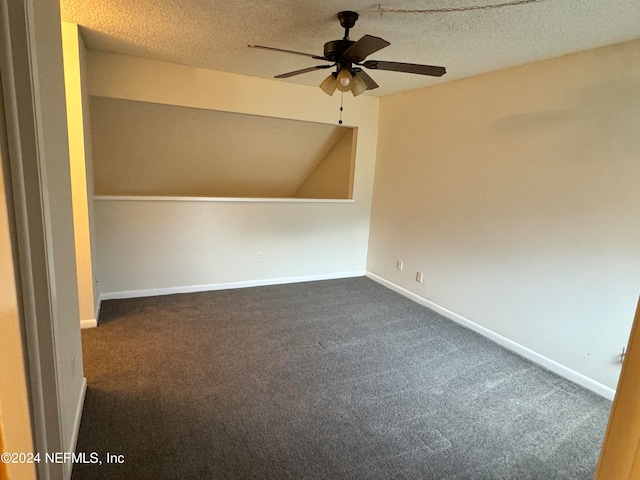 carpeted spare room with ceiling fan and a textured ceiling