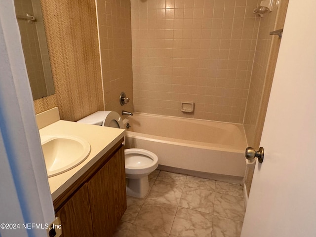 full bathroom featuring toilet, tiled shower / bath combo, and vanity