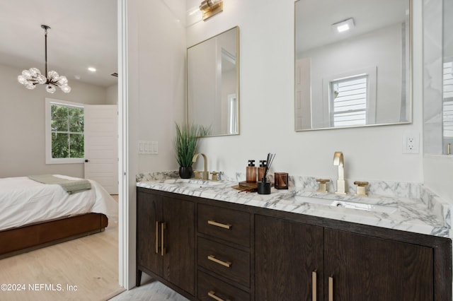 bathroom featuring vanity, a chandelier, and hardwood / wood-style floors