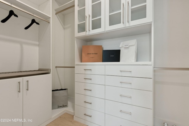 walk in closet featuring light hardwood / wood-style floors