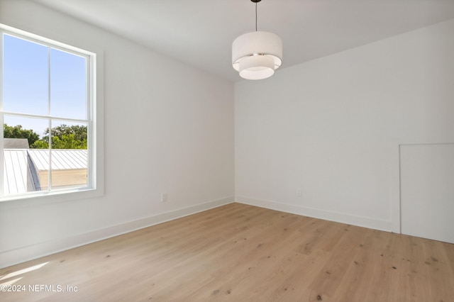 unfurnished room with light wood-style floors and baseboards