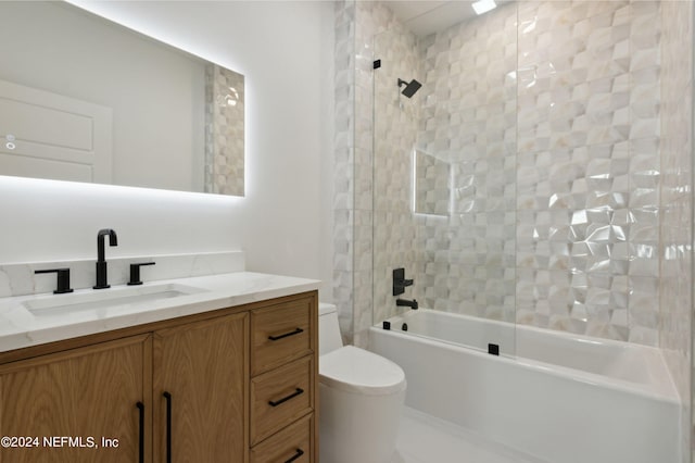 full bathroom with vanity, tiled shower / bath, and toilet