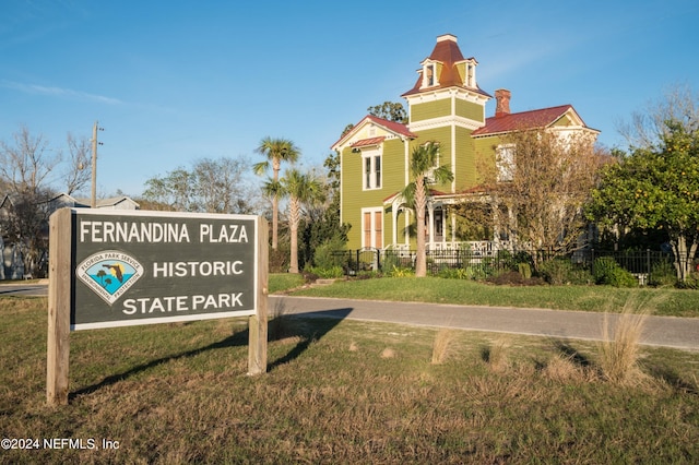 surrounding community with fence and a lawn