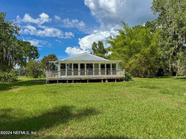 rear view of house with a yard