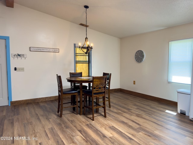 dining space with a chandelier and hardwood / wood-style floors