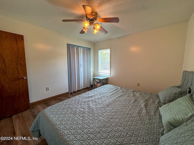 bedroom featuring a textured ceiling, hardwood / wood-style floors, and ceiling fan