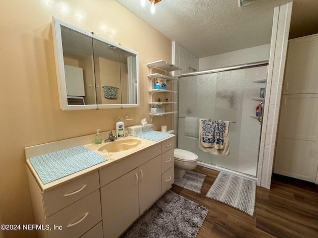 bathroom with vanity, toilet, hardwood / wood-style flooring, and an enclosed shower