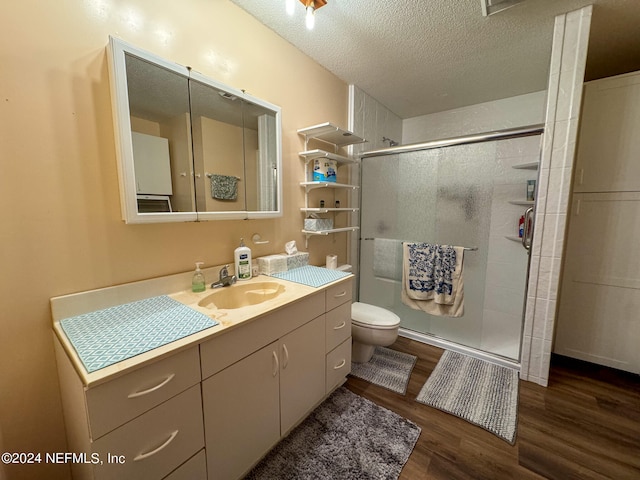 bathroom with vanity, toilet, hardwood / wood-style flooring, and walk in shower