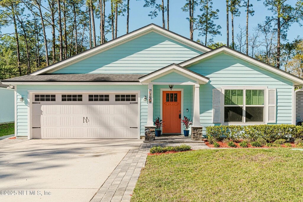 4951 Verdis St, Jacksonville, FL 32258 - view of front facade featuring a garage, concrete driveway, and a front yard