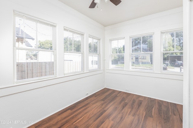 unfurnished sunroom with ceiling fan