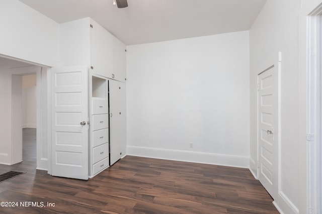 unfurnished bedroom with ceiling fan and dark hardwood / wood-style floors