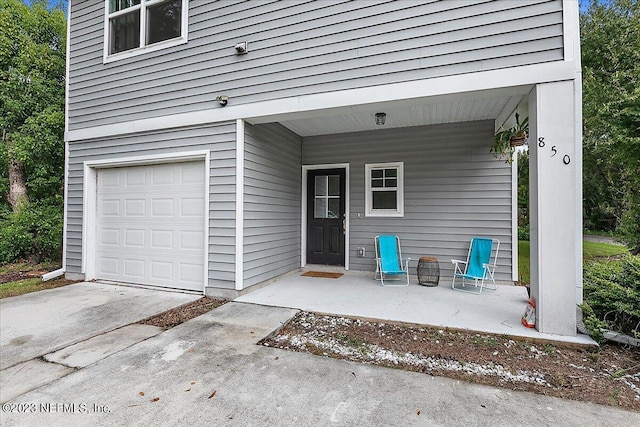 doorway to property with a garage