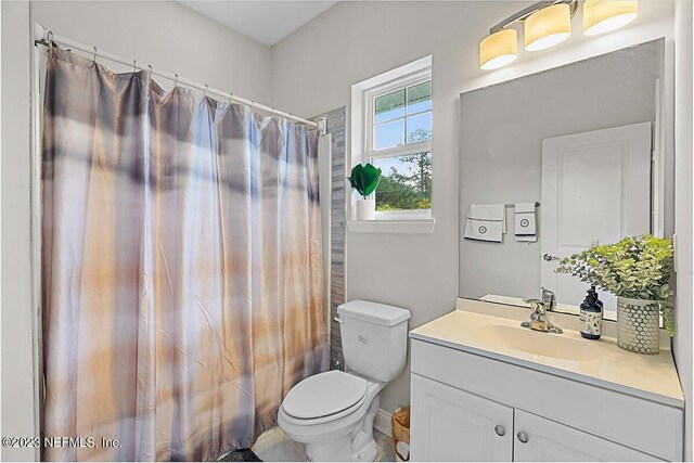 bathroom with vanity, toilet, and a shower with shower curtain