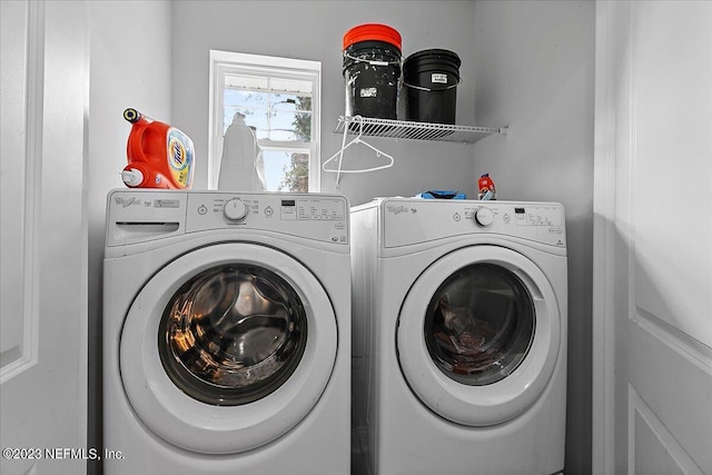 clothes washing area with washing machine and clothes dryer