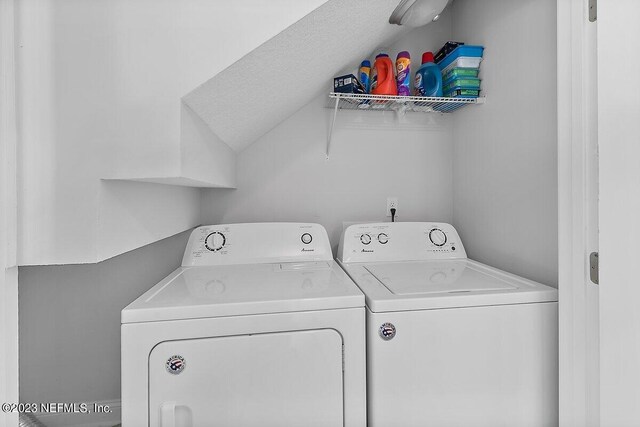 washroom with washing machine and clothes dryer