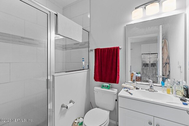 bathroom with vanity, toilet, and an enclosed shower