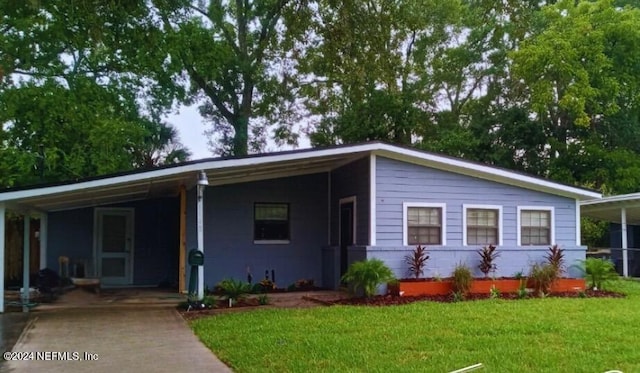 view of front facade with a carport and a front lawn