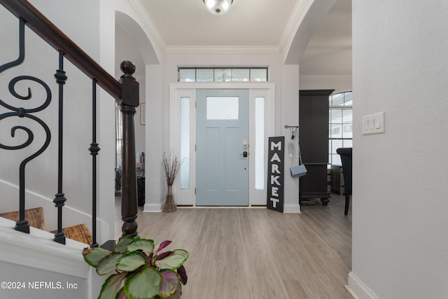 foyer featuring light hardwood / wood-style flooring and ornamental molding