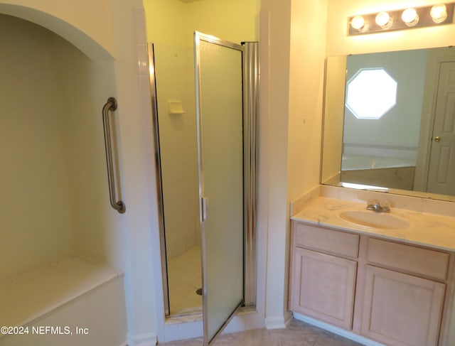 bathroom featuring walk in shower and vanity