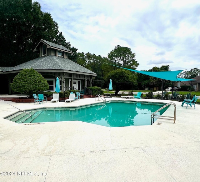 view of pool featuring a patio area