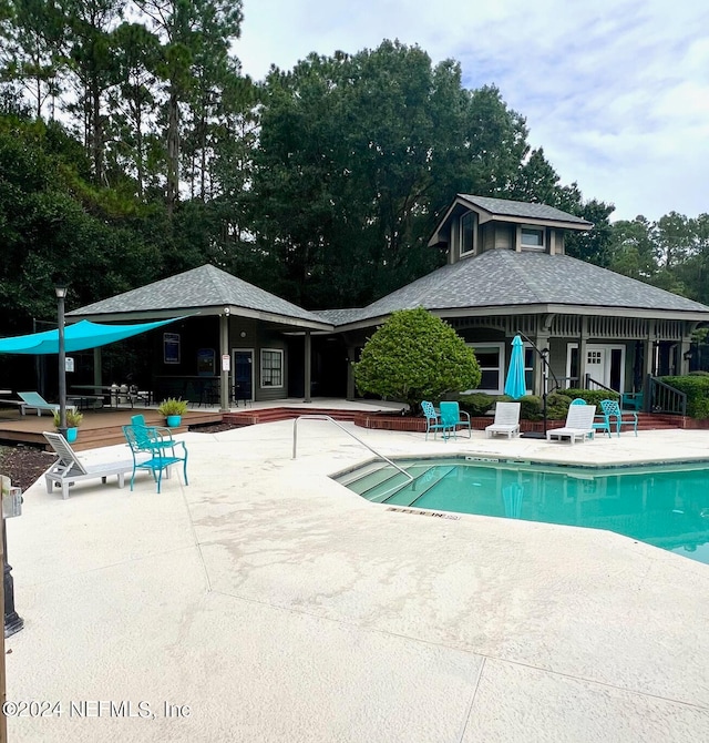 view of pool featuring french doors and a patio area