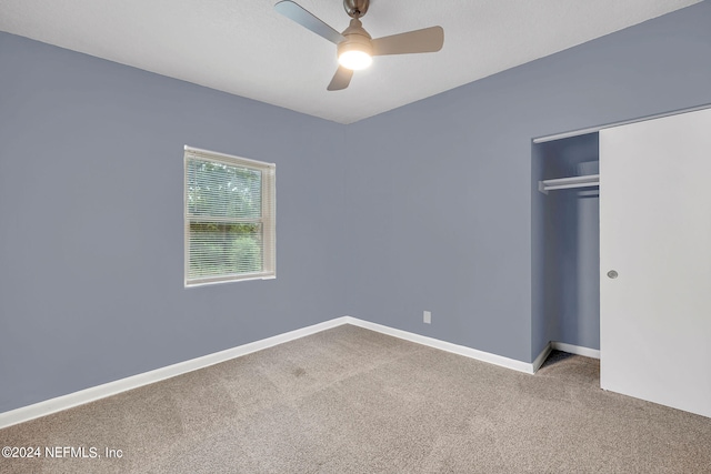 unfurnished bedroom featuring a closet, ceiling fan, and carpet floors